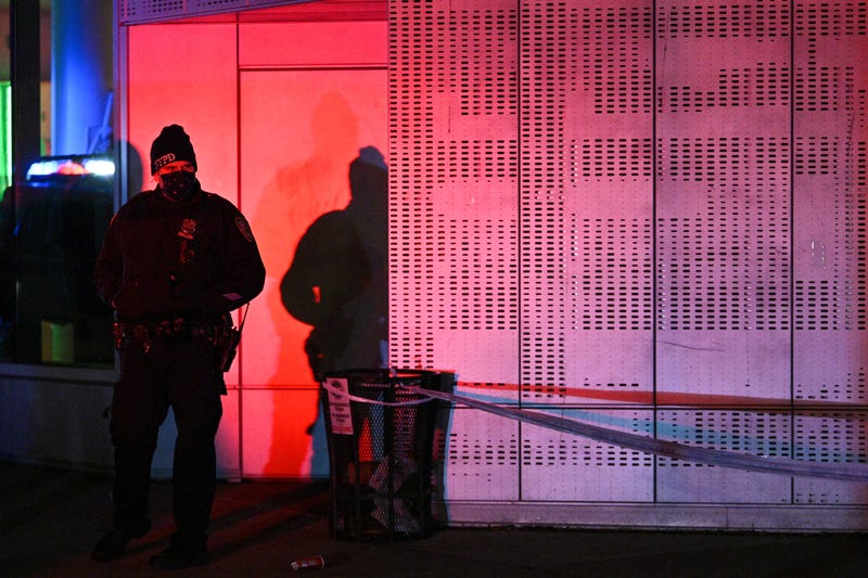 Police officers lock down the scene after two NYPD officers were shot in Harlem on January 21, 2022 in New York City.