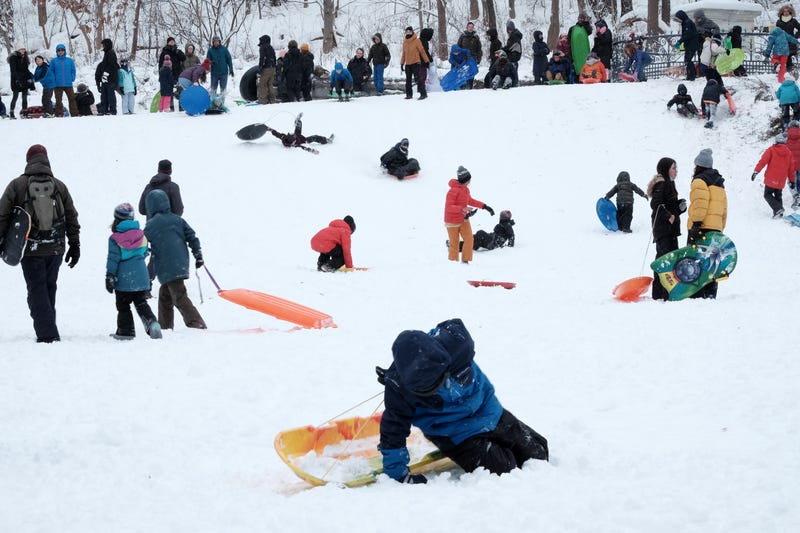 People go sledding in Prospect Park following a major snowstorm on January 29, 2022 in the Brooklyn borough of New York City.