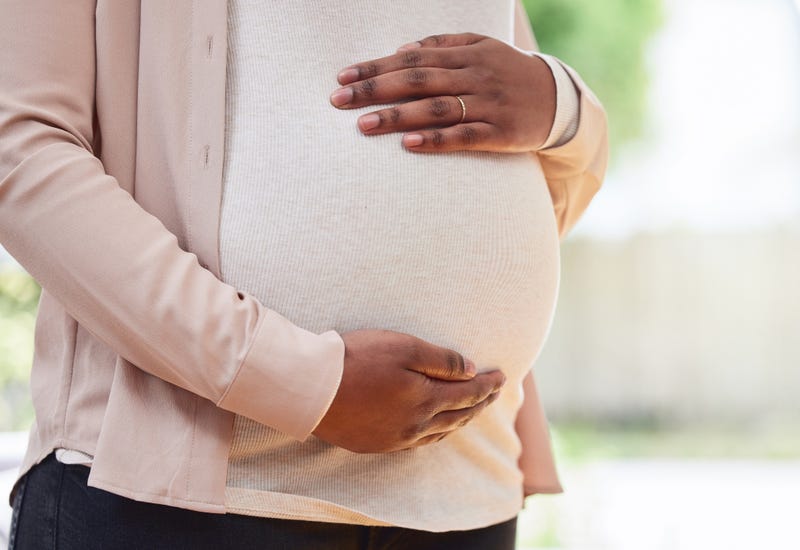 A pregnant Black woman.