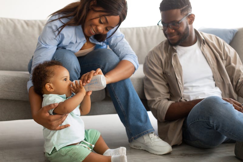 Toddler drinks milk.