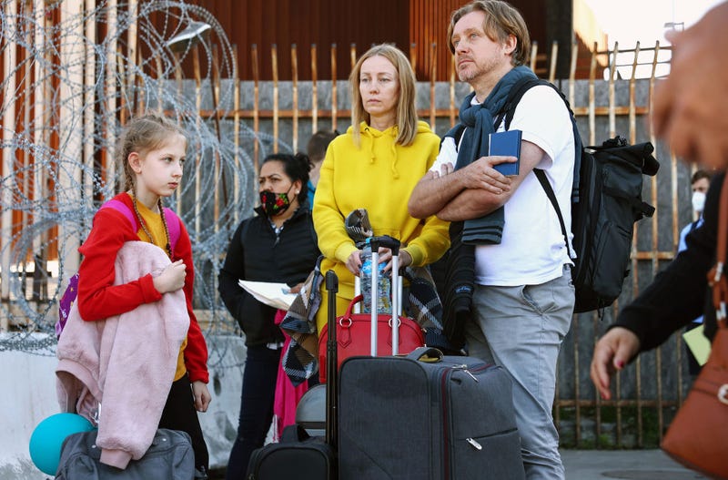 A Ukrainian family who fled Kyiv, Ukraine wait with their luggage before being allowed to cross the San Ysidro Port of Entry into the United States to seek asylum on March 22, 2022 in Tijuana, Mexico. U.S. authorities have recently been allowing Ukrainian refugees to enter the U.S. at the Southern border in Tijuana with permission to remain in the U.S. on humanitarian parole for one year.