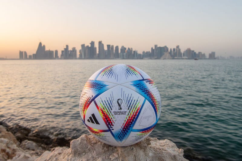 n this photo illustration an official FIFA World Cup Qatar 2022 ball sits on display in front of the skyline of Doha