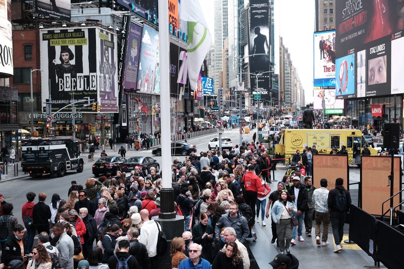People wait in line to buy theater tickets in Times Square on April 27, 2022 in New York City