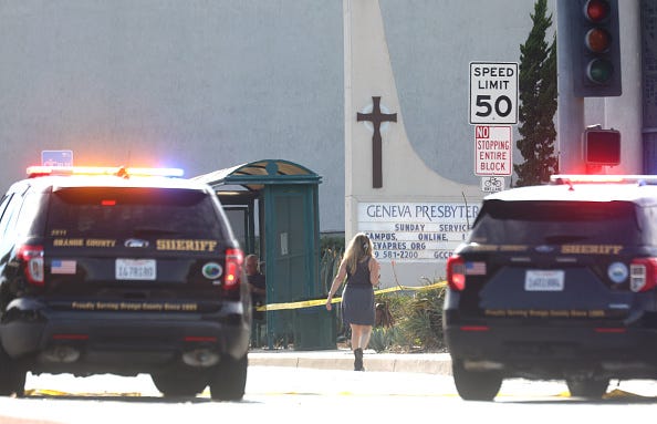 Police vehicles are parked near the scene of a shooting at the Geneva Presbyterian Church on May 15, 2022 in Laguna Woods, California. According to police, the shooting left one person dead, four critically wounded, and one with minor injuries.