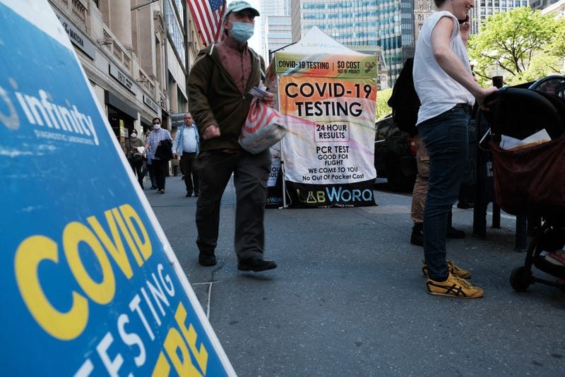 People walk past a COVID testing site on May 17, 2022 in New York City.