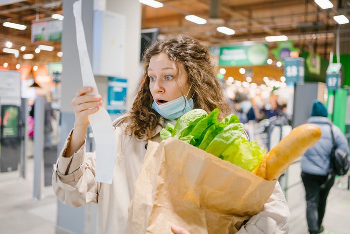 Person checking the prices on their receipt.