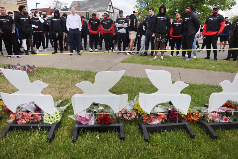 Members of the Buffalo Bills lay flowers at a memorial near the Tops supermarket where ten people were killed last Saturday on May 18, 2022 in Buffalo, New York.