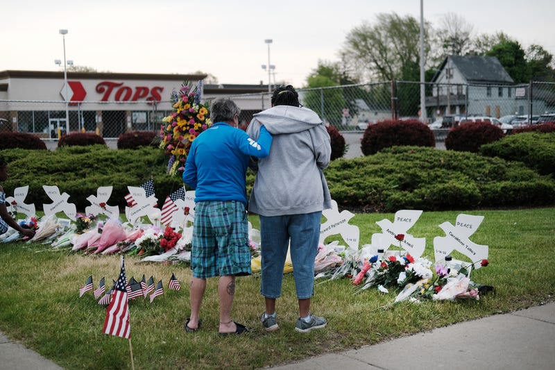 People gather at a memorial for the shooting victims outside of Tops market on May 20, 2022 in Buffalo, New York.
