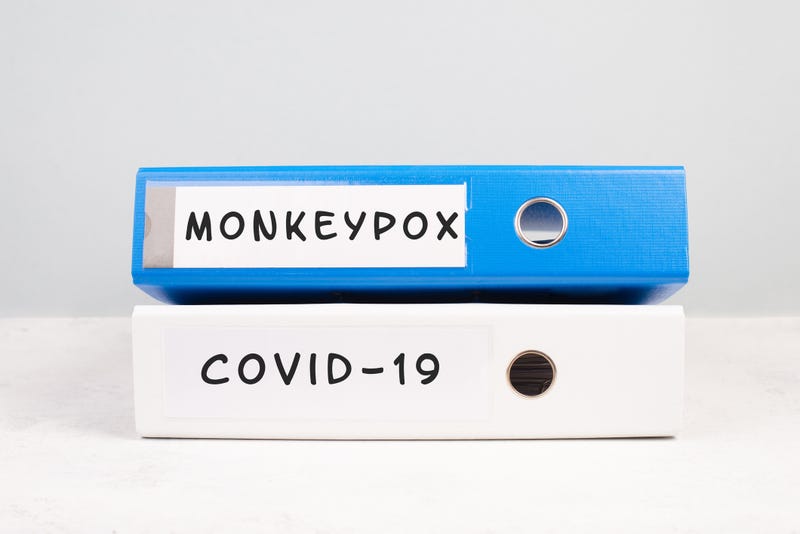 Binders with "COVID-19" and "monkeypox" written on the spines.