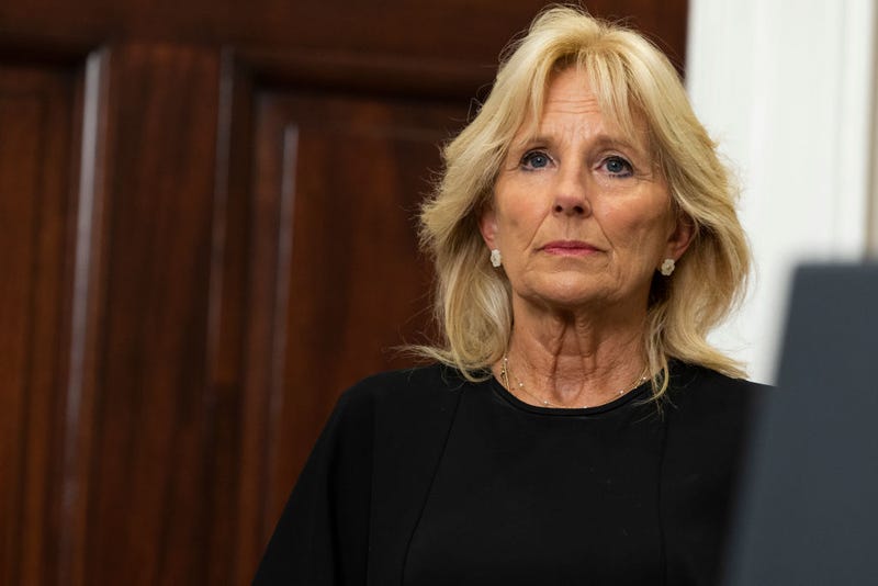 U.S. first lady Jill Biden listens as President Joe Biden delivers remarks from the Roosevelt Room of the White House.