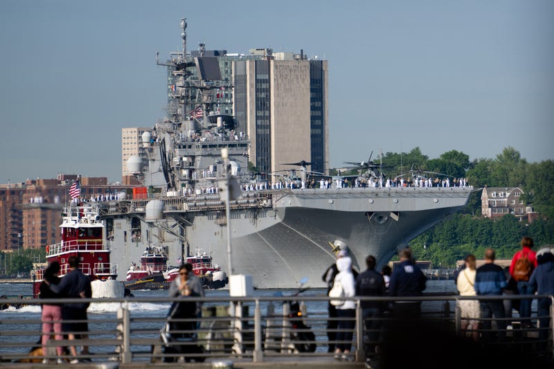 People gather around to watch Marines and Navy sailors from the USS Bataan during their arrival for Fleet Week 2022 as seen from the Intrepid Museum on May 25, 2022 in New York City. Fleet Week returned this year in full capacity with over 3,000 sailors partaking across multiple vessels entering New York City’s ports, according to reports. This is the first year since the start of the COVID-19 pandemic that Fleet Week has returned.