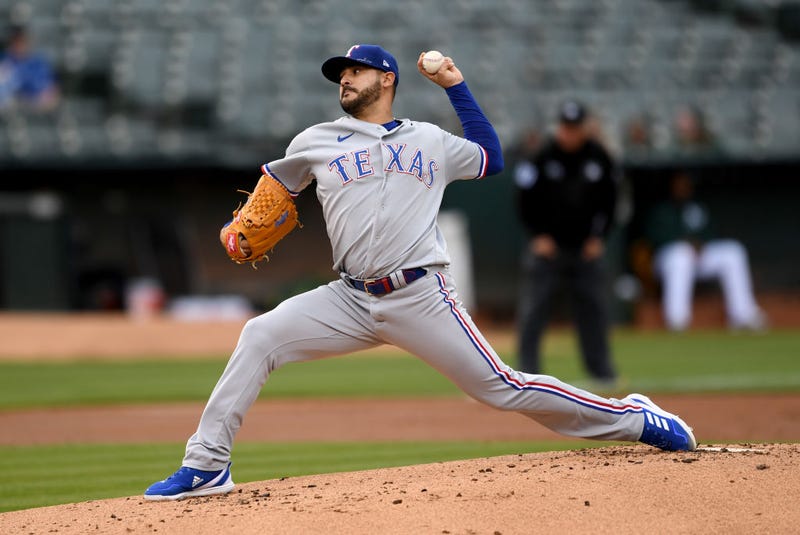 Martin Perez #54 of the Texas Rangers pitches in the bottom of the first inning against the Oakland Athletics at RingCentral Coliseum on May 26, 2022 in Oakland, California.