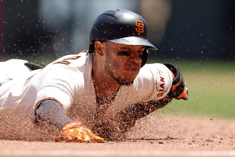 Thairo Estrada #39 of the San Francisco Giants slides in to third base for a triple that scored a run in the second inning against the Colorado Rockies at Oracle Park on June 09, 2022 in San Francisco, California.