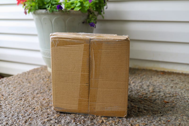 shipping package sitting on the front porch of a home