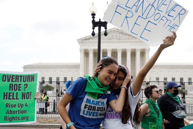 Abortion rights activists Carrie McDonald (L) and Soraya Bata react to the Dobbs v Jackson Women’s Health Organization ruling which overturns the landmark abortion Roe v. Wade case in front of the U.S. Supreme Court on June 24, 2022 in Washington, DC. 