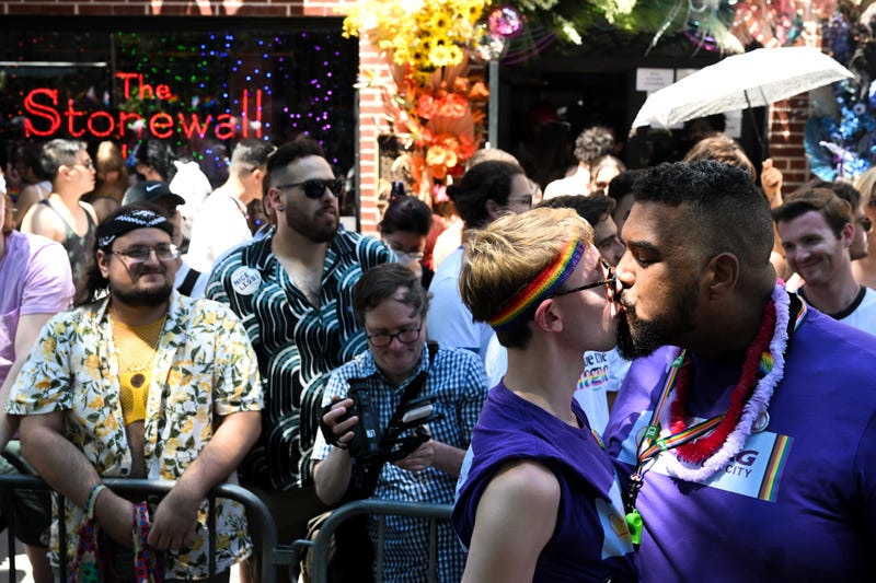 Ben Eisenstadt from New York and Paul Staisiunas from New York kiss for photographers in front of the Stonewall Inn the New York City Pride Parade on June 26, 2022 in New York City.