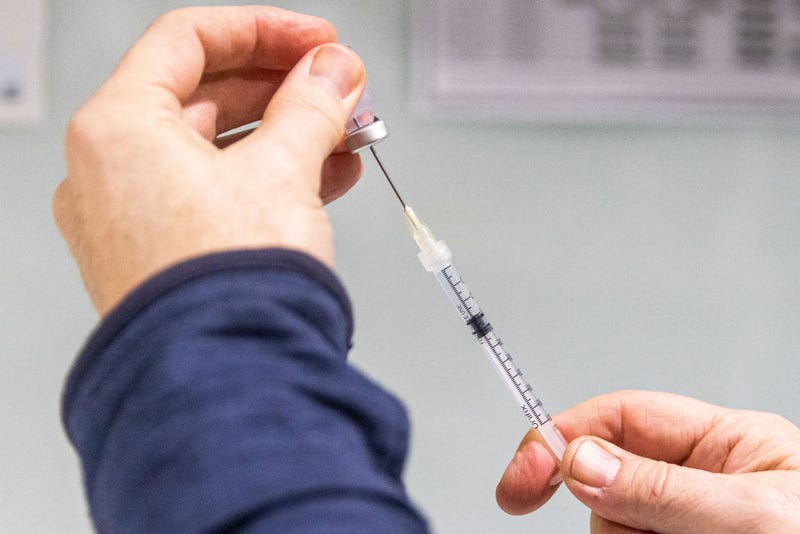 A pharmacist prepares a COVID-19 vaccination booster shot for a customer at the Exhibition Pharmacy on July 11, 2022 in Melbourne, Australia.