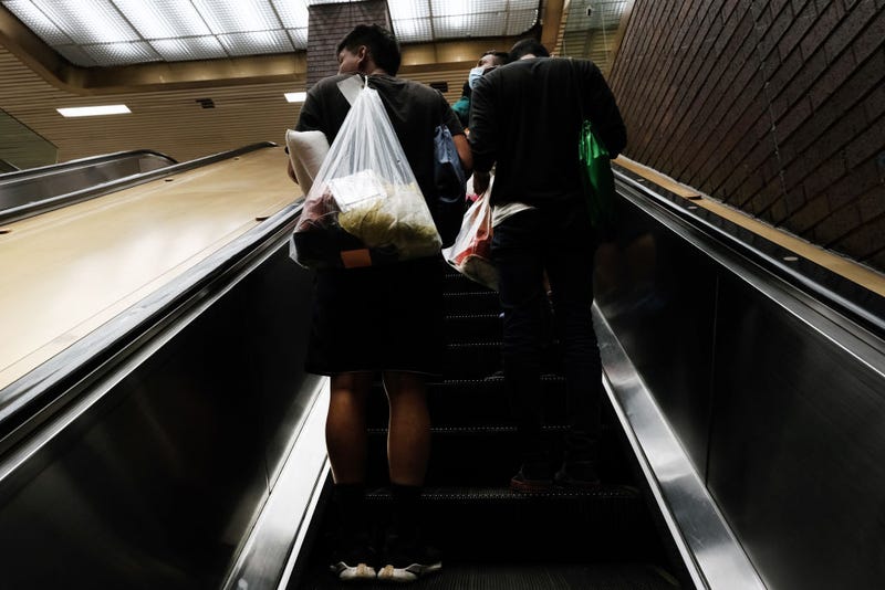 Migrants who crossed the border from Mexico into Texas walk through the Port Authority bus station in Manhattan after arriving by bus on August 25, 2022 in New York City.