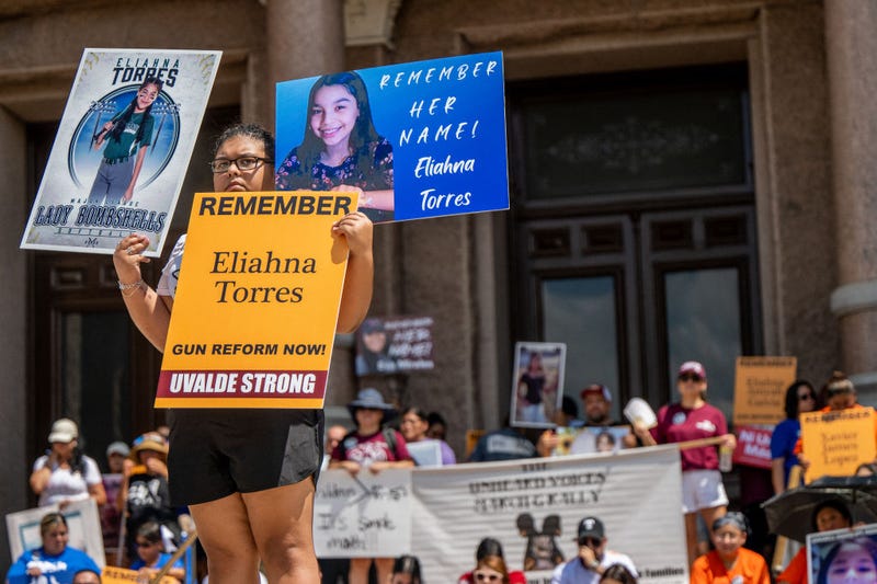 The Torres family stand holding signs of Eliahna Torres, one of the children murdered during the mass shooting at Robb Elementary School, during a March For Our Lives rally on August 27, 2022 in Austin, Texas. 'March For Our Lives' and activists rallied with parents from Uvalde and Santa Fe at the Texas Capitol, where they demanded that Gov. Greg Abbott calls a special session to raise the minimum age to 21 for the purchase of assault weapons. (Photo by Brandon Bell/Getty Images)