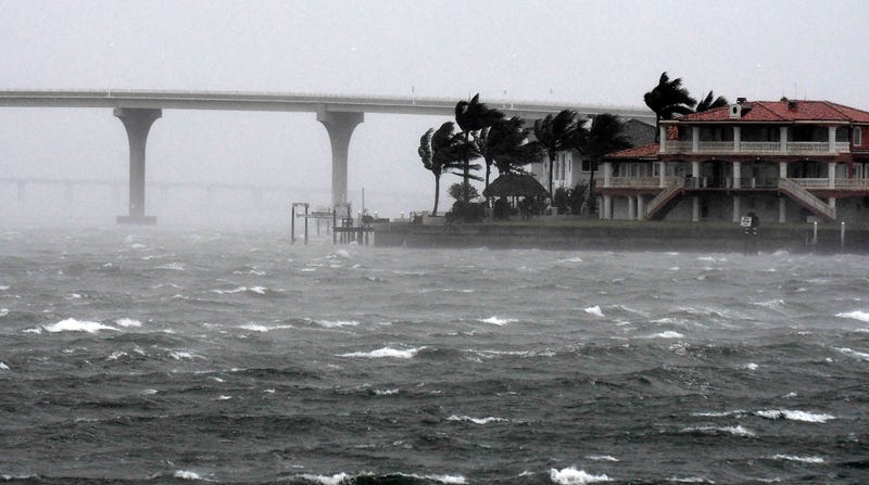 rain and big waves near bridge and resort in florida