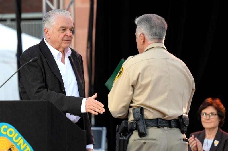 Nevada Gov. Steve Sisolak (L) and Clark County Sheriff Joe Lombardo shake hands during the 1 October Sunrise Remembrance ceremony