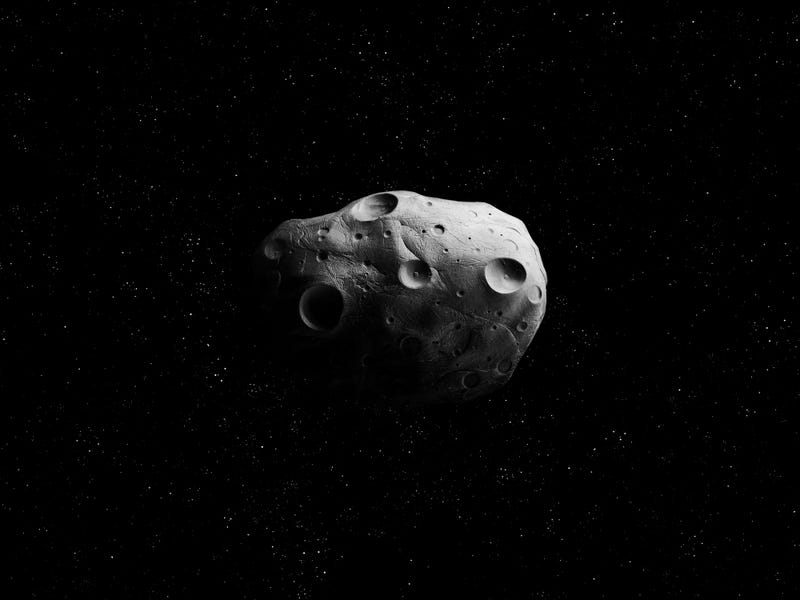 Meteorite with impact craters on the surface.