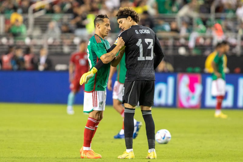 Andres Guardado #18 of Mexico put the captain's armband on Guillermo Ochoa #13 during a game between Colombia and Mexico at Levi's Stadium on September 27, 2022 in Santa Clara, California.
