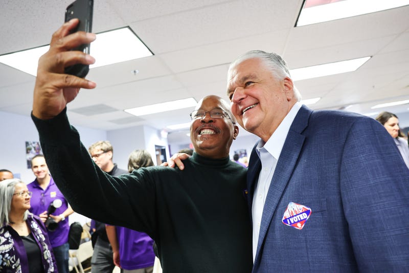 Nevada Gov. Steve Sisolak (R) poses for a selfie with a union worker at an SEIU union worker election day rally on November 08, 2022 in Las Vegas, Nevada