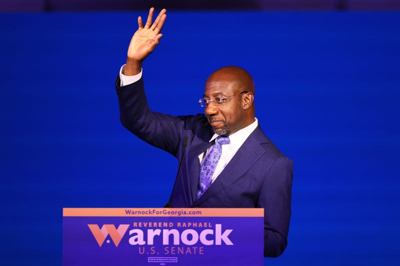 Senator Raphael Warnock waving