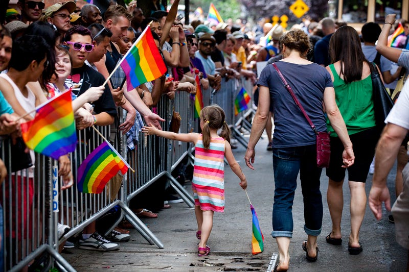 A girl hi-fives reveler as she marches in the New York City Gay Pride March on June 24, 2012 in New York City. The annual civil rights demonstration commemorates the Stonewall riots of 1969, which erupted after a police raid on a gay bar, the Stonewall Inn on Christopher Street. (Photo by Michael Nagle/Getty Images)
