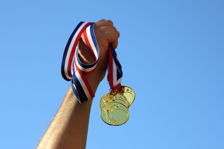 Man holding gold medals