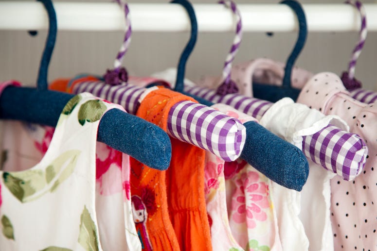 Girl's clothes hanging in closet