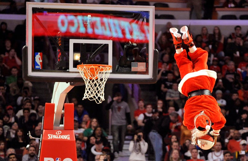 santa shooting a big hoop on the basketball court on christmas