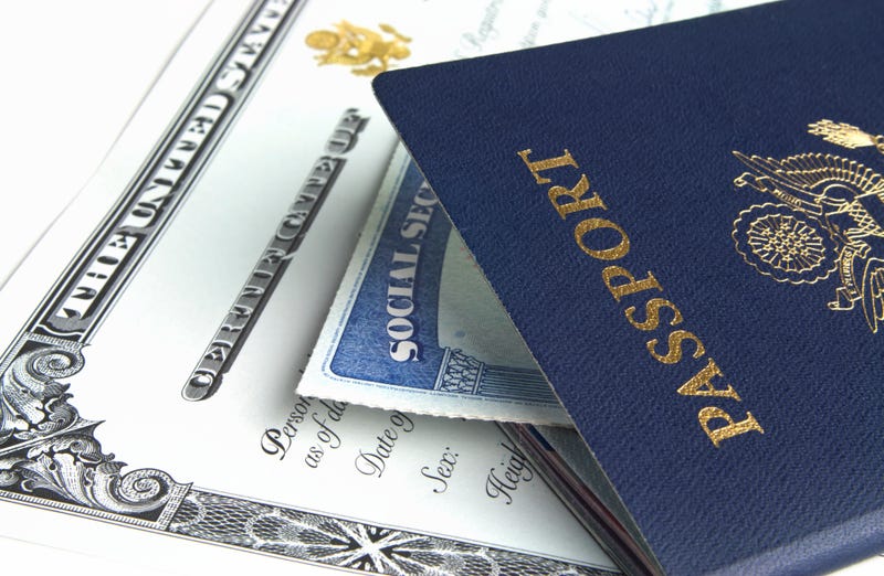 Blue American passport with citizenship documents on white background.