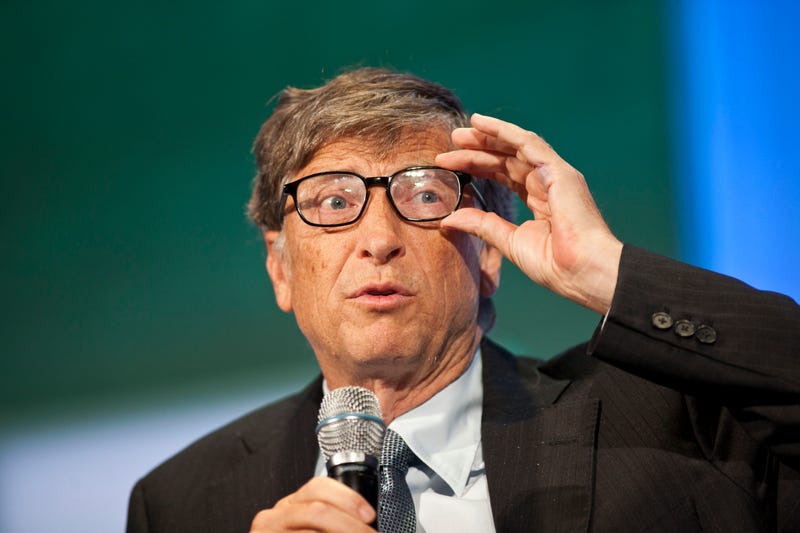bill gates adjusts glasses on stage