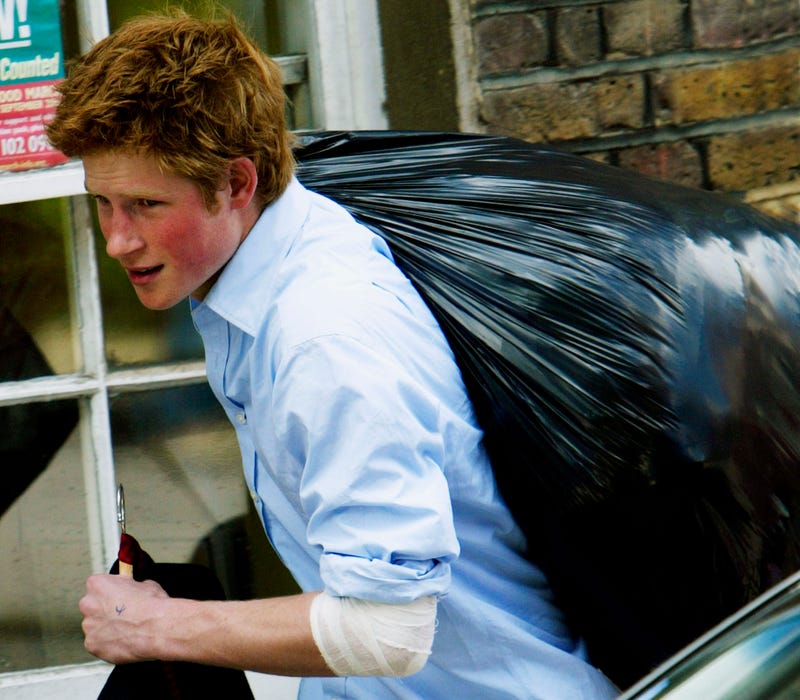prince harry carrying out a plastic bag of belongings on his last day at eton college in 2003