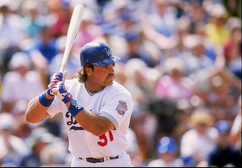 Catcher Mike Piazza of the Los Angeles Dodgers signs autographs during a spring training game against the New York Mets at the Holman Stadium in Vero Beach, Florida.