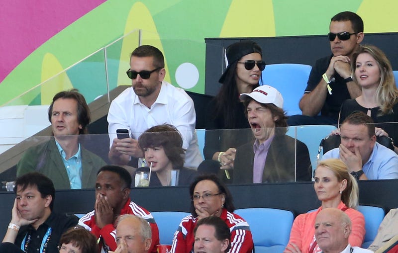 mick jagger yawns at soccer game with his son