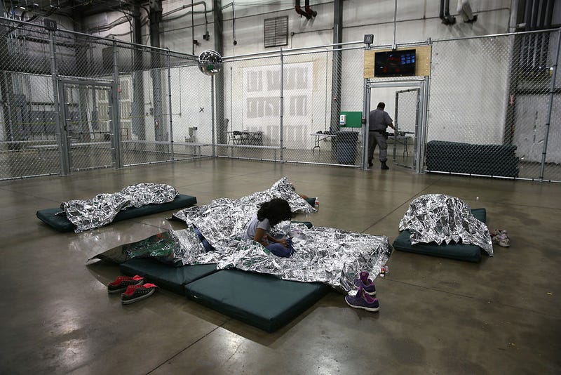 A girl from Central America rests on thermal blankets at a detention facility run by the U.S. Border Patrol on September 8, 2014 in McAllen, Texas