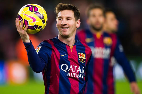 Lionel Messi of FC Barcelona with the match ball after scoring three goals during the La Liga match between FC Barcelona and RCD Espanyol at Camp Nou on December 7, 2014 in Barcelona, Spain.