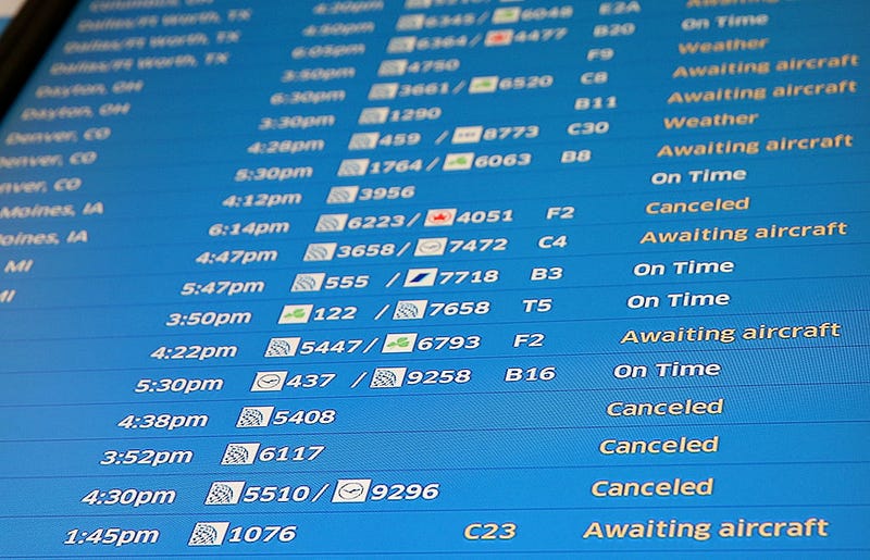 flight board with cancellations and delays