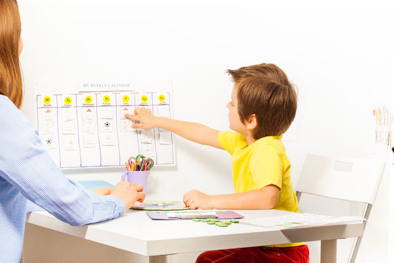 mother and son sit at their calendar