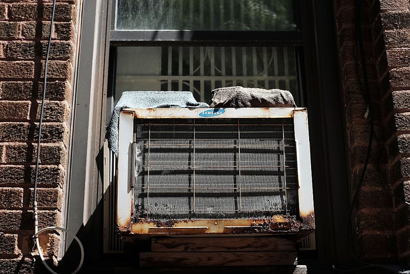 An air conditioner is viewed in a window at Brighton Beach in Brooklyn on August 20, 2015 in New York City.