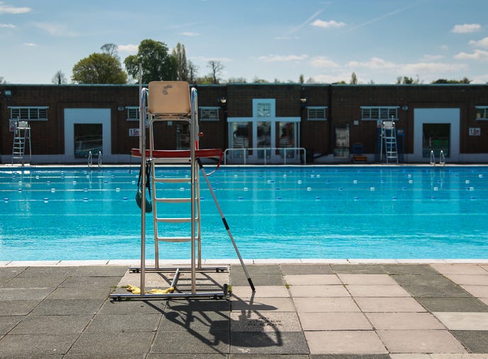 empty lifeguard stand at the pool