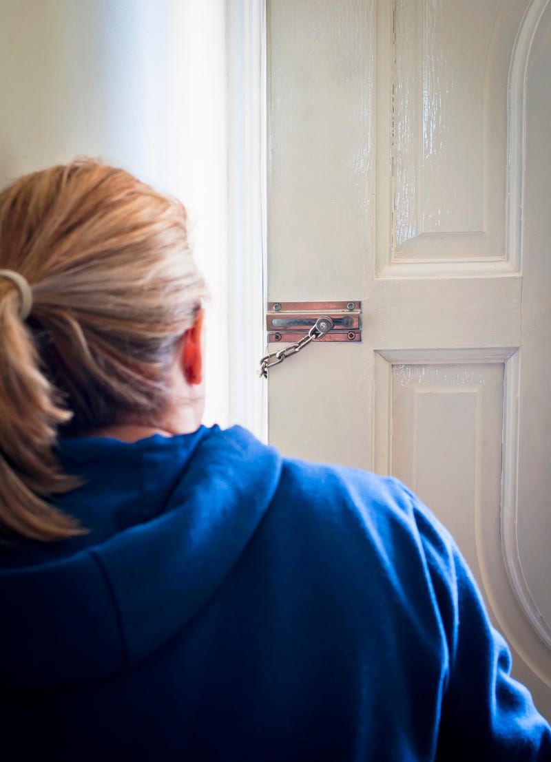 Woman checking door stock photo.