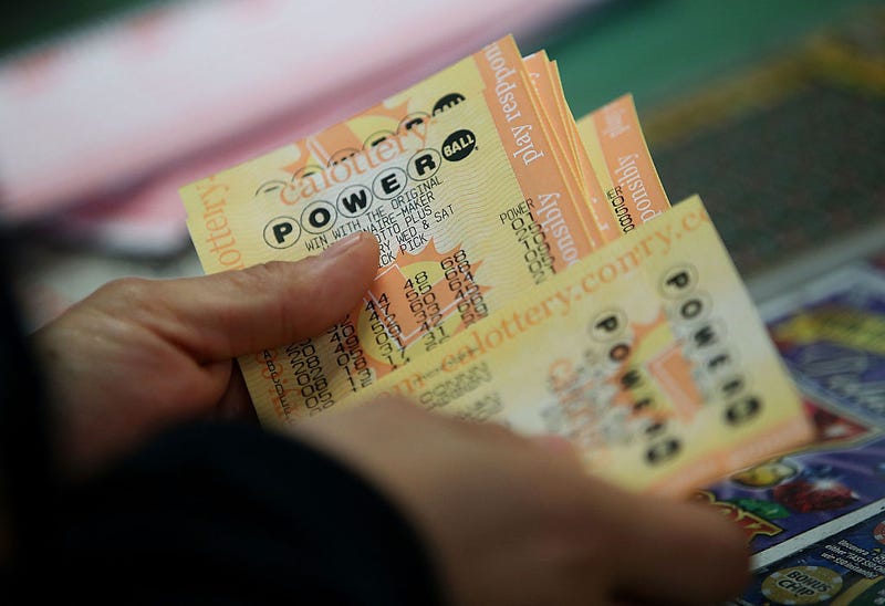 Person holding Powerball tickets