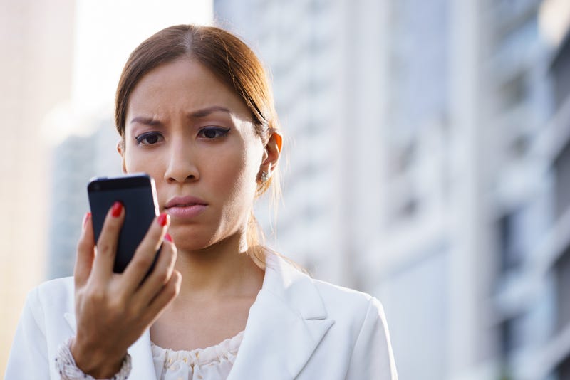 woman looks at phone