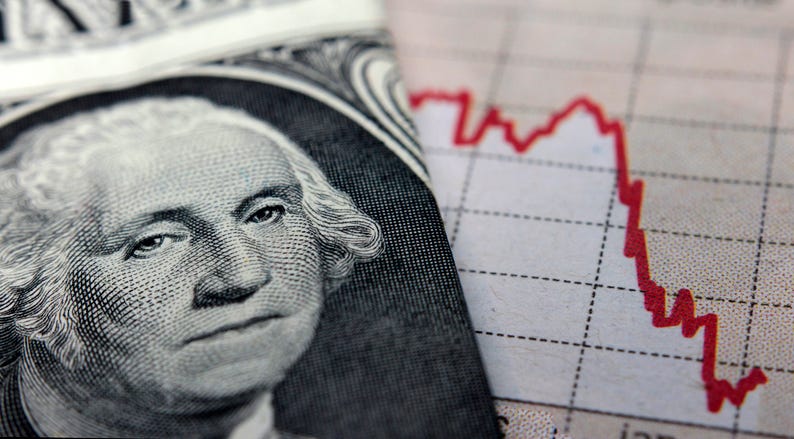 A dollar bill by a declining graphic depicting recession.