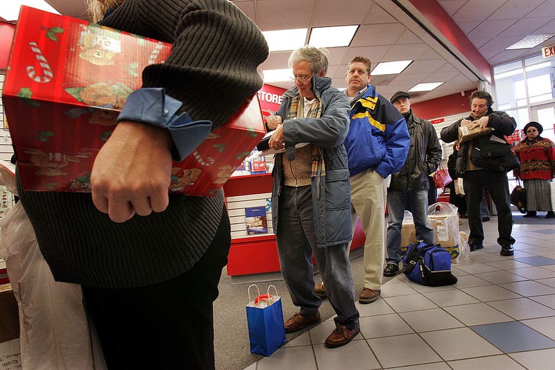 U.S. Postal Service customers wait in line to mail Christmas presents at a U.S. Post Office December 20, 2004 in Washington, DC.
