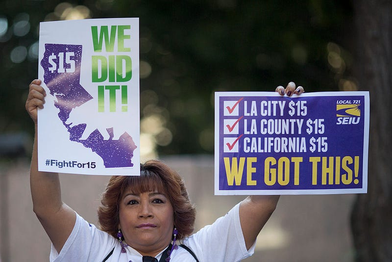 A Service Employees International Union member celebrates after California Governor Jerry Brown signed landmark legislation SB 3 into law on April 4, 2016 in Los Angeles, California.